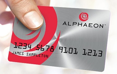 Hand holding Alphaeon credit card
