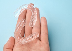 Hand holding two Clear Aligners trays