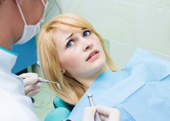 Woman afraid in the dental chair