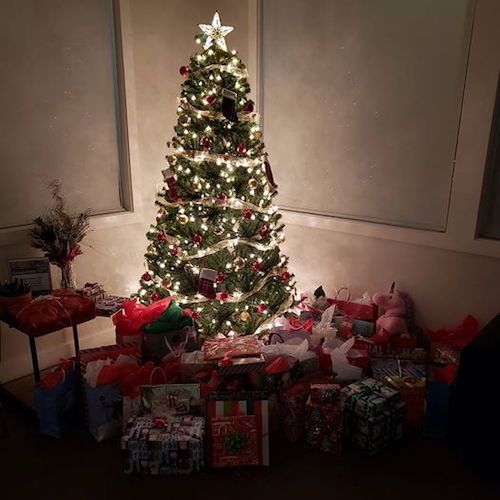 Pile of wrapped presents under Christmas tree