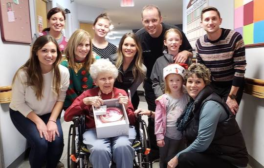 Amberly Dental team smiling with senior woman in wheelchair