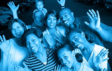 Group of people smiling and waving