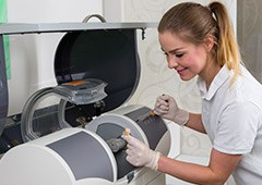 Dental assistant creating a C E R E C same day dental crown