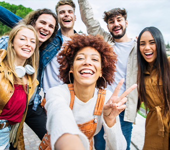 Group of young adults taking selfie outdoors