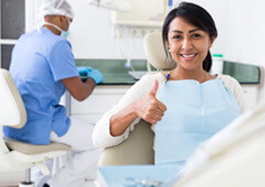 a dental patient giving thumbs up