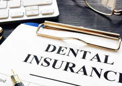 a dental insurance form near a keyboard