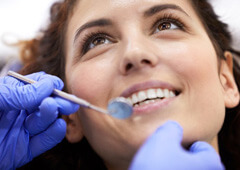 a patient smiling during a dental checkup and cleaning