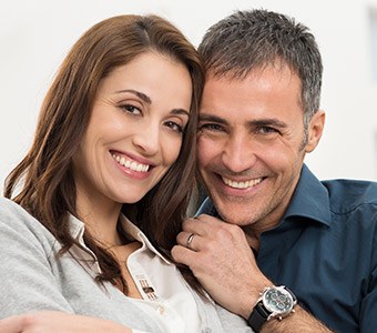 husband and wife smiling