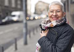 Senior woman smiling and wearing scarf