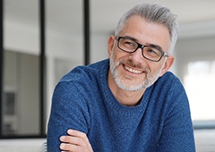 man smiling with arms crossed