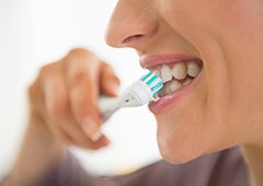 closeup of person brushing teeth