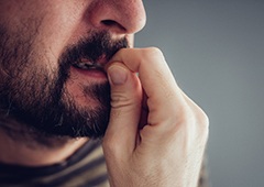 man biting fingernails