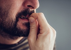 man biting fingernails 