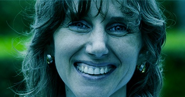 Close up of smiling senior woman with silver earrings