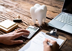 Dental patient filling out paperwork at desk