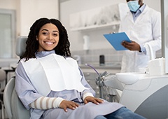 Woman smiling while sitting in treatment chair