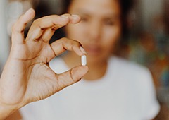 Woman holding a pill