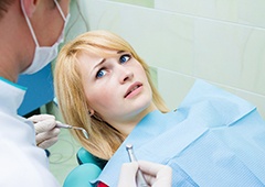 Woman afraid in the dental chair