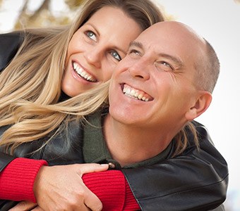 man and woman laughing and smiling