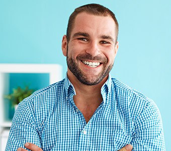 man in blue button down shirt smiling