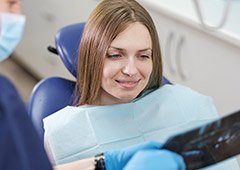 woman smiling at dental x ray