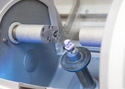 A same-day porcelain crown being created inside a milling unit powered by CEREC technology