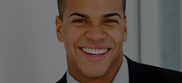 Young man in suit smiling