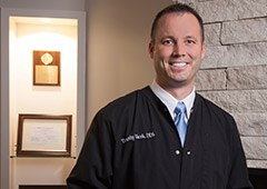 Doctor Vacek smiling in hallway of Amberly Dental