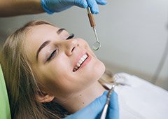 Woman relaxing while getting dental checkup