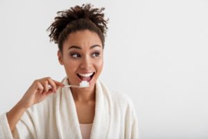 Woman brushing her teeth to boost her immune system