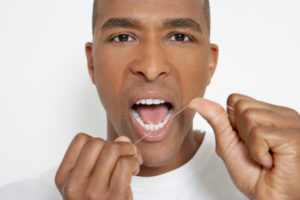 man flossing thanks to tips from the dentist waverly residents prefer